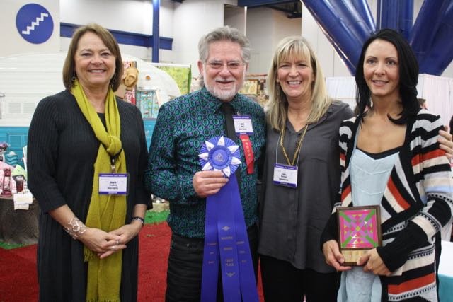 Cheryl Freydberg, Mark Dunn, Lissa Alexander, and Holly Hickman celebrate Moda's Best Booth award. Will the tradition continue?