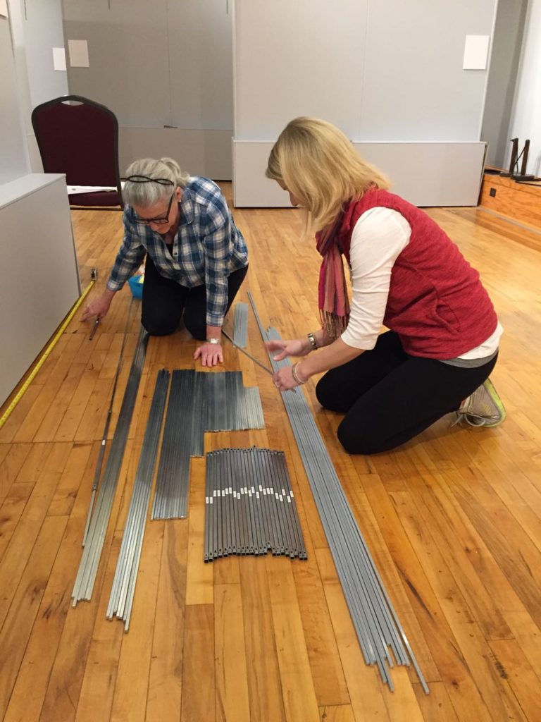 On Jan. 25, Marianne and Megan sorted the hanging rods in preparation for the new show.